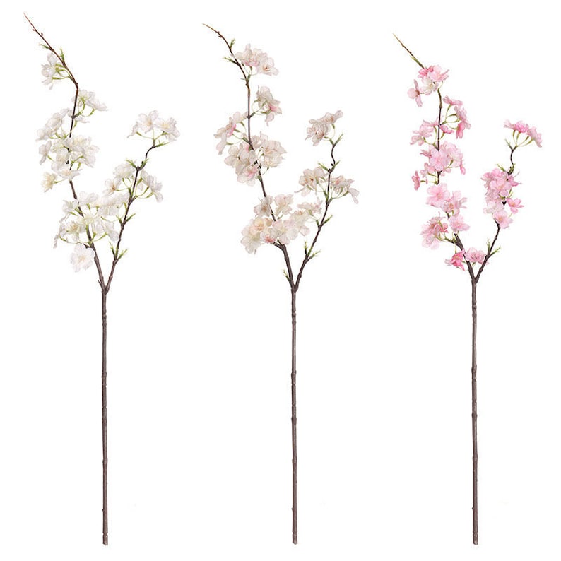 May include: Three artificial cherry blossom branches with white and pink flowers. The branches are long and slender, with delicate leaves.