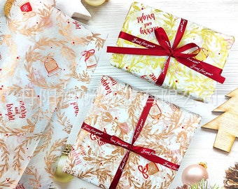 May include: Christmas-themed gift wrapping. Presents wrapped in patterned paper with red ribbon. The paper features festive designs like bells, wreaths, and the text "merry and bright." Decorative elements include ornaments and pine cones.