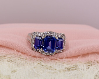 10K White Gold Imitation Tanzanite and White Cubic Zirconia 3 Stone Halo Ring