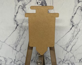 May include: A brown cardboard syringe shape on a wooden easel with a clear badge holder.