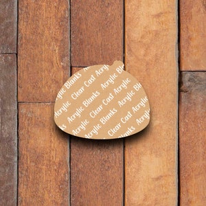 May include: A brown paper backing sheet with the text "Acrylic Clear Cast Acrylic Blanks" repeated on it.