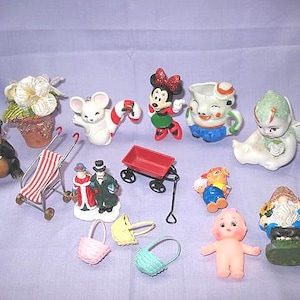 May include: A collection of miniature figurines and accessories, including a bear holding a fish, a mouse with a candy cane, a Minnie Mouse figure, a red wagon, a baby doll, and a garden gnome. Other items include a stroller, baskets, and a fairy.