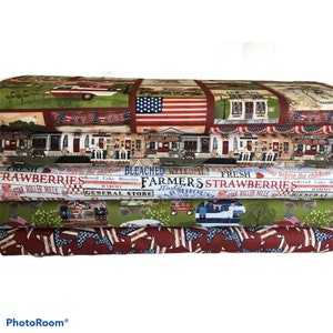 May include: A stack of four fabric panels featuring a patriotic theme with red, white, and blue stars and stripes. The panels also feature images of a general store, a farmhouse, and a red, white, and blue pickup truck. The text on the panels reads "Fresh Strawberries", "Farmers Market", "Bleached", "Welcome", and "General Store".