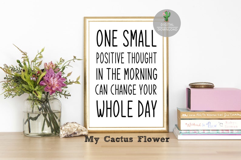 May include: A gold framed printable wall art with a white background and black text that reads "One small positive thought in the morning can change your whole day". The text is in a handwritten font. Below the text is the phrase "My Cactus Flower".