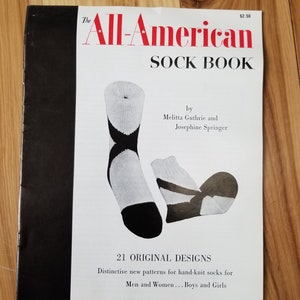 May include: The All-American Sock Book by Melitta Guthrie and Josephine Springer. A book cover with a white background and black text. The book features 21 original designs for hand-knitted socks.