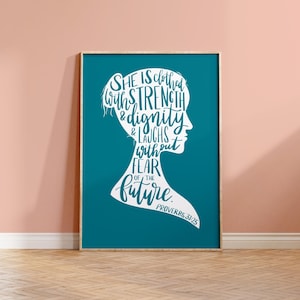 May include: A rectangular wall art print featuring a teal background with a white silhouette of a person's profile. The silhouette contains the white text: She is clothed with strength & dignity & laughs without fear of the future. Proverbs 31:25.