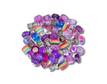 May include: A collection of colourful glass and metal beads in shades of purple, pink, and rainbow. The beads are designed for use in jewellery making, particularly for charm bracelets.