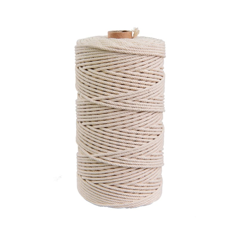 May include: A spool of natural cotton rope, wound tightly and ready for crafting projects.