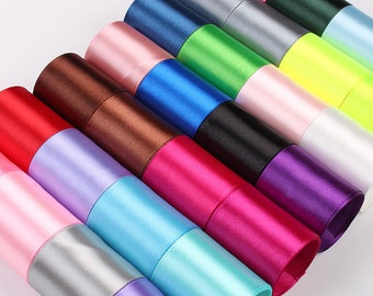 May include: Assortment of satin ribbon rolls in various colors, including red, pink, lavender, light blue, turquoise, silver, purple, magenta, dark purple, black, blue, green, yellow, and white.