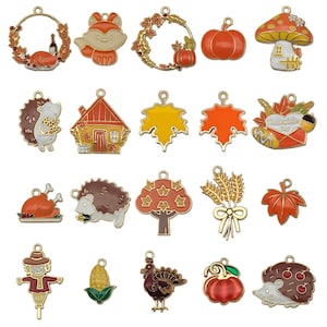May include: Set of 20 enamel charms with autumn and Thanksgiving themes. Charms feature images of pumpkins, leaves, turkeys, houses, and more. Charms are gold-toned with colourful enamel details.