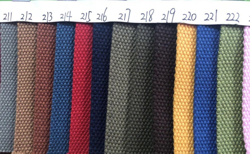 May include: A color chart of fabric swatches, numbered 211 to 222, showing a variety of colors and textures. The swatches are arranged in a horizontal row.