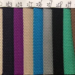 May include: A swatch card with 16 different fabric samples. The samples are arranged in a row from left to right. The fabric samples are all different colors and textures. The numbers 249 through 264 are printed above each sample.