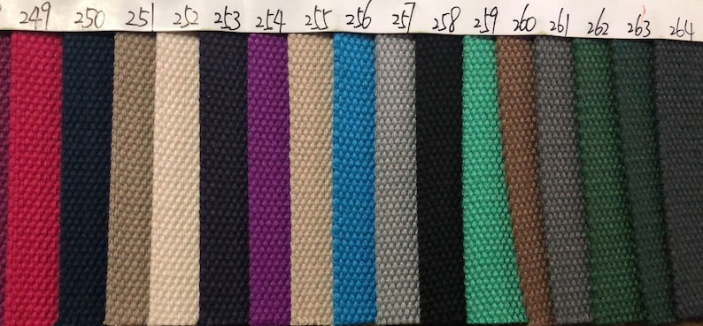 May include: A swatch card with 16 different fabric samples. The samples are arranged in a row from left to right. The fabric samples are all different colors and textures. The numbers 249 through 264 are printed above each sample.