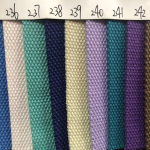 May include: A close-up of 11 fabric swatches in various colors, including green, blue, white, beige, purple, teal, and brown. The swatches are numbered 234 through 244.