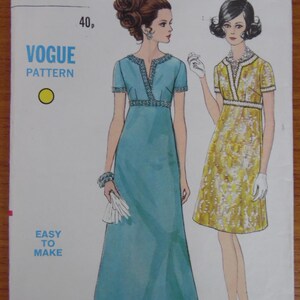 May include: A Vogue sewing pattern envelope 7490 for a size 12 dress with a 34 inch bust. The illustration shows two variations: a floor-length solid blue dress and a knee-length yellow patterned dress, both featuring short sleeves and trim.