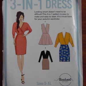 May include: A sewing pattern titled "3-IN-1 DRESS" featuring illustrations of three dress styles. The pattern includes sizes S-XL. The cover art shows a woman in a red polka-dot dress. The text says the pattern is easy to make and wear.