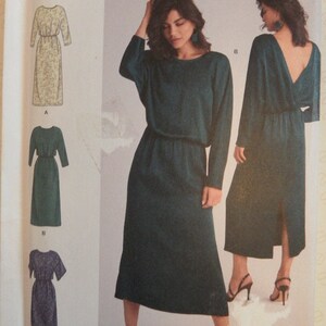 May include: Simplicity sewing pattern K9010, showing a dark teal dress with long sleeves and a back slit. The pattern includes sizes U.S. 14-22. The words "easy-to-sew" are printed on the top left corner. The pattern is from Simplicity.