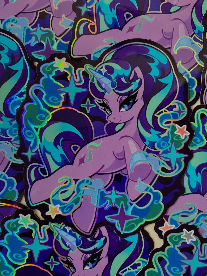 May include: A holographic sticker featuring a purple unicorn with a blue and green mane and tail. The unicorn is surrounded by stars and clouds. The sticker has a shiny, iridescent finish.