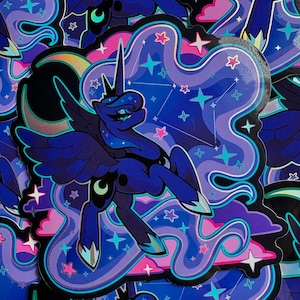 May include: A die-cut sticker featuring a dark blue winged pony with a horn, a crescent moon cutie mark, and flowing mane. The background displays swirling purple and pink clouds, bright teal stars, and a constellation against a dark blue sky.
