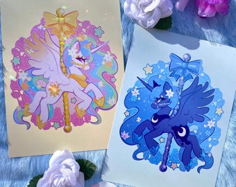 May include: Two illustrated prints of the My Little Pony characters Princess Celestia and Princess Luna. Celestia is a white unicorn with a golden mane and tail, and Luna is a black unicorn with a blue mane and tail. Both are depicted on a carousel horse, with a star-shaped background.
