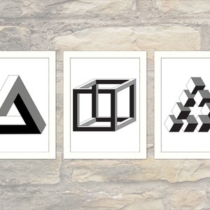 May include: Three black and white optical illusion prints in white frames. The prints feature a triangle, a cube, and a pyramid.