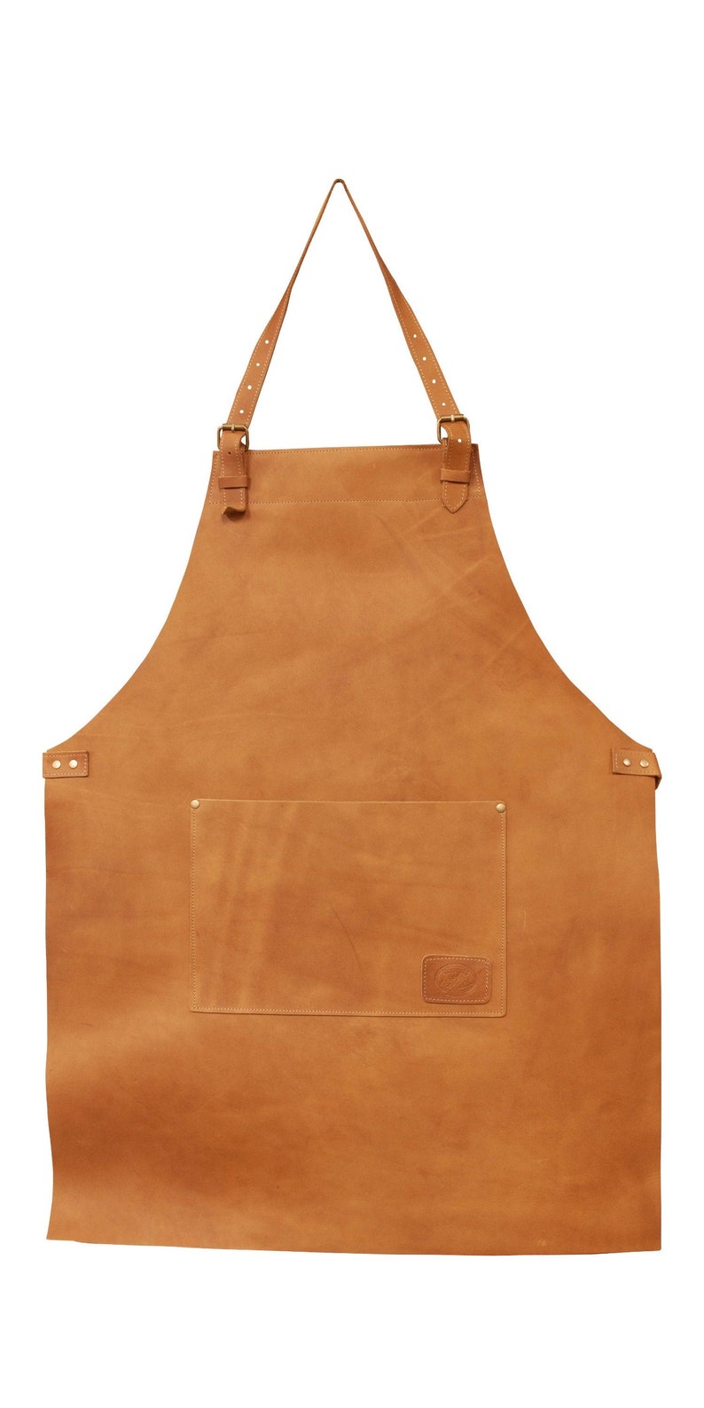 May include: A brown leather apron with adjustable straps and a large pocket. The apron has a small leather patch with a logo on the front.