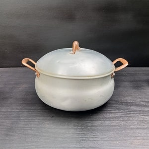 Vintage aluminum pan with copper handles. Old manufactory copper-aluminum pot from Italy of 50s. Retro metal utensils