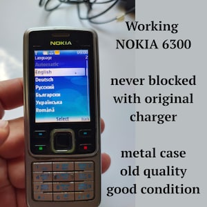 Working never blocked mobile phone NOKIA 6300 push-button cell phone in black and silver, Retro mobile with charger  from 2000s