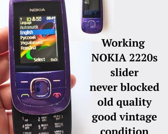 Working never blocked mobile phone NOKIA 2220s push-button slider cell phone in purple, Retro vintage mobile phone from 2000s