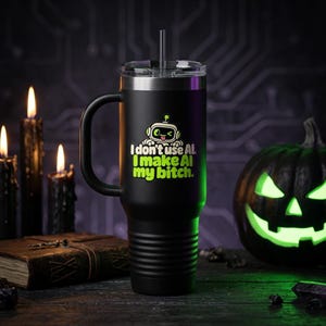 May include: A matte black stainless steel tumbler with a handle, a clear lid, and a straw. The front features a white and green graphic of a winking robot with the text: I don't use AI. I make AI my bitch. The base has horizontal ridges.