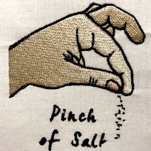 May include: Embroidered image of a hand making a pinching gesture with the text "Pinch of Salt" below.