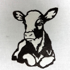 May include: Embroidered image of a black and white calf, resting on a white fabric. The calf is depicted in a detailed, realistic style, with the black areas of the calf's coat contrasting against the white background.