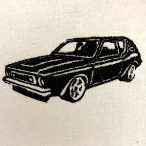 May include: Black embroidered car design on a white fabric. The car is a classic hatchback style, with detailed stitching outlining the body, windows, and wheels. The embroidery is dense, creating a textured appearance.
