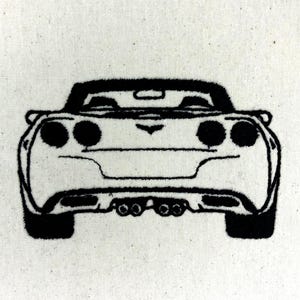 May include: Black and white embroidered design of a sports car's rear view. The car features round taillights, a spoiler, and exhaust pipes. The design is on a light-colored fabric.