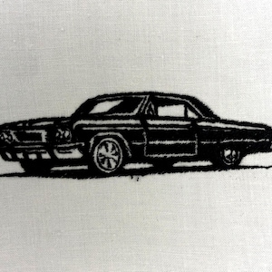 May include: Black embroidered classic car design on a white background. The car is a vintage coupe with detailed wheels and body lines, showcasing a retro automotive theme. The embroidery has a textured appearance.