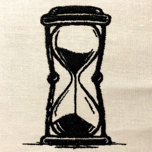 May include: A black and white hourglass with a rounded top and a bulbous bottom. The hourglass is sitting on a white surface.