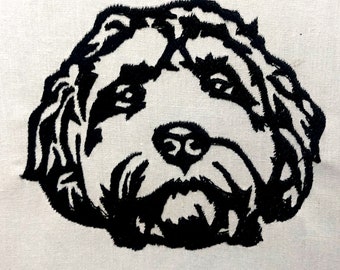 May include: Black and white embroidered image of a dog's face on a white canvas.