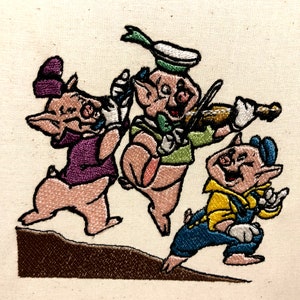 May include: Three embroidered piglets with pink bodies, one playing a violin, one wearing a purple hat and one wearing a blue hat and overalls.