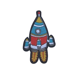 May include: A colorful embroidered patch of a rocket ship with flames coming out of the back. The rocket is blue, red, yellow, and white.
