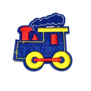May include: A blue felt applique of a train with red and yellow details. The train has a chimney with smoke coming out of it.