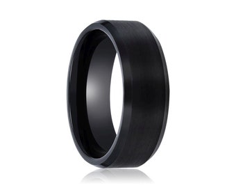 May include: A black tungsten carbide ring with a brushed finish.