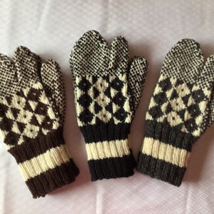 May include: Three pairs of knitted mittens with a geometric pattern in brown, black, and white.