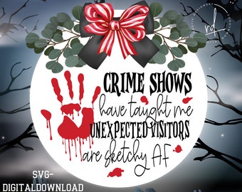 May include: A white circle with a red bloody handprint and the text "CRIME SHOWS have taught me UNEXPECTED VISITORS are sketchy AF". The circle is surrounded by a green leafy garland and a red and white striped bow.