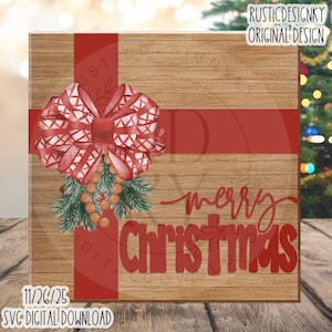 May include: A square wooden sign with a red bow and the words "merry christmas" in red script. The bow is decorated with a watercolor design and greenery. The sign also includes the text "SVG DIGITAL DOWNLOAD".