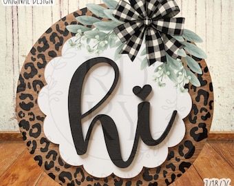 May include: A round wooden sign featuring a leopard print border and a white scalloped centre with the black text hi and a small heart. The sign is decorated with a black and white buffalo plaid bow and green eucalyptus leaves. Text reads RUSTICDESIGNKY ORIGINAL DESIGN and 7/18/26 SVG DIGITAL DOWNLOAD.