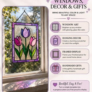 May include: Stained glass window art featuring three tulips in shades of pink and purple, with green stems and leaves. The artwork is framed in a purple border and hangs in a window. Text on the image says "WINDOWS, DECOR & GIFTS".