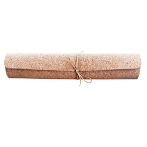 May include: A rolled-up cork yoga mat tied with a brown string.