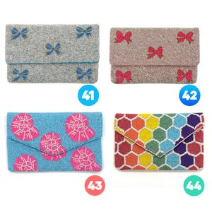 May include: Four rectangular beaded clutch bags. Number 41 is silver with blue bows. Number 42 is champagne with pink bows. Number 43 is light blue with pink seashell motifs. Number 44 features a multicolored honeycomb pattern in a geometric design.