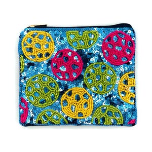 May include: A blue zippered pouch with a colorful beaded design. The pouch is decorated with circles of yellow, green, pink, and blue beads.