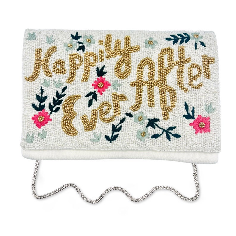 May include: A white beaded clutch with a gold chain strap. The clutch has a floral design and the words "Happily Ever After" beaded in gold.